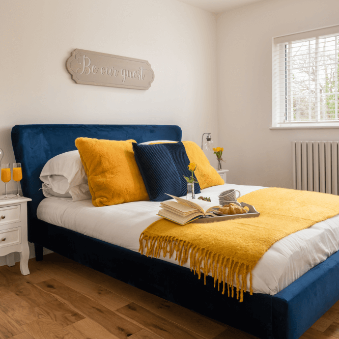 Comfortable bedroom with blue bedding in a holiday let