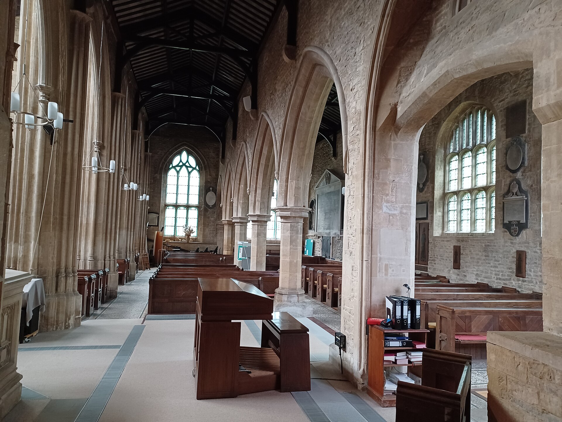 Stone arches, wooden pews and stained-glass windows inside St Mary