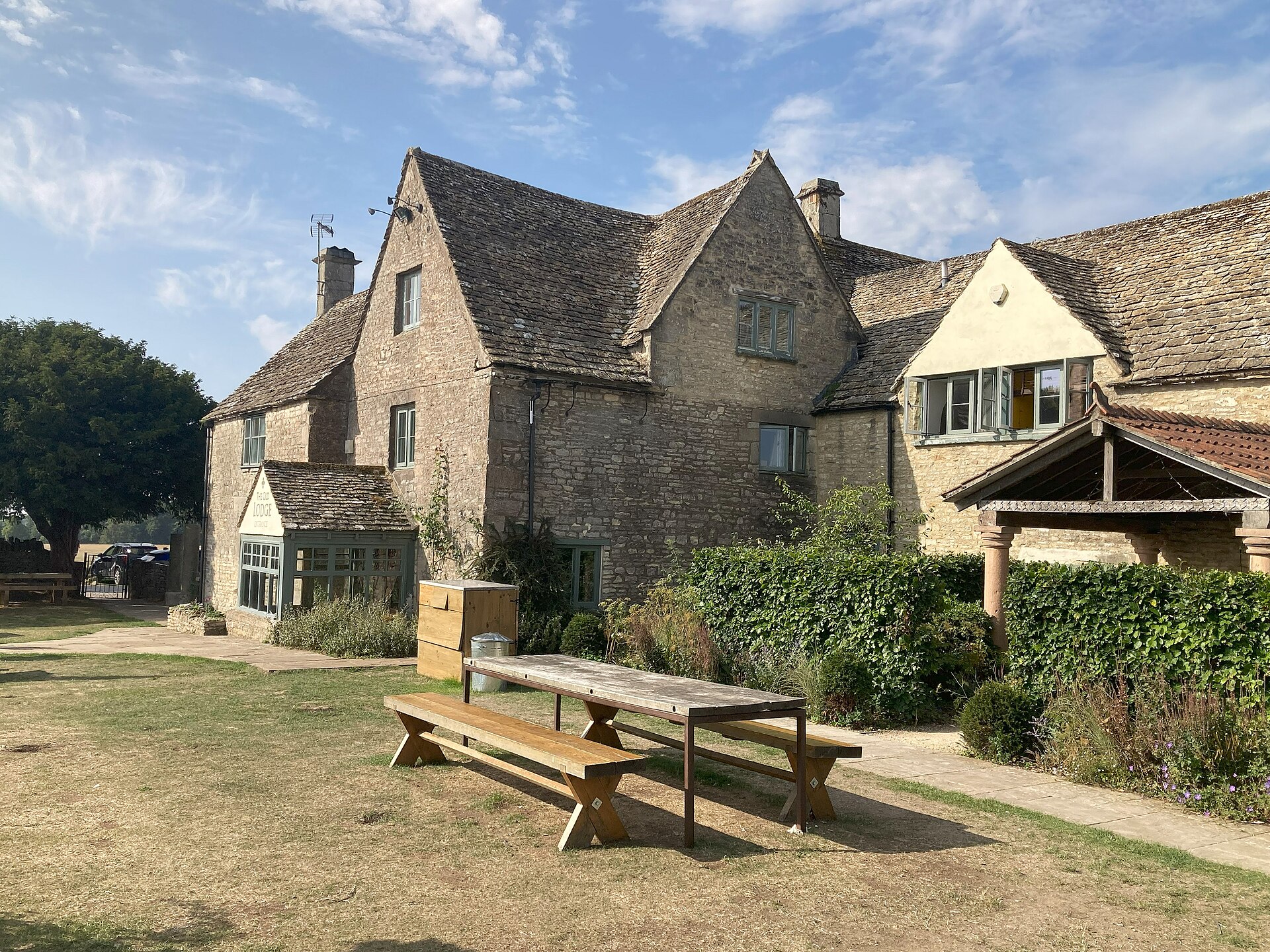 Stone frontage and picnic table in the garden of the Old Lodge