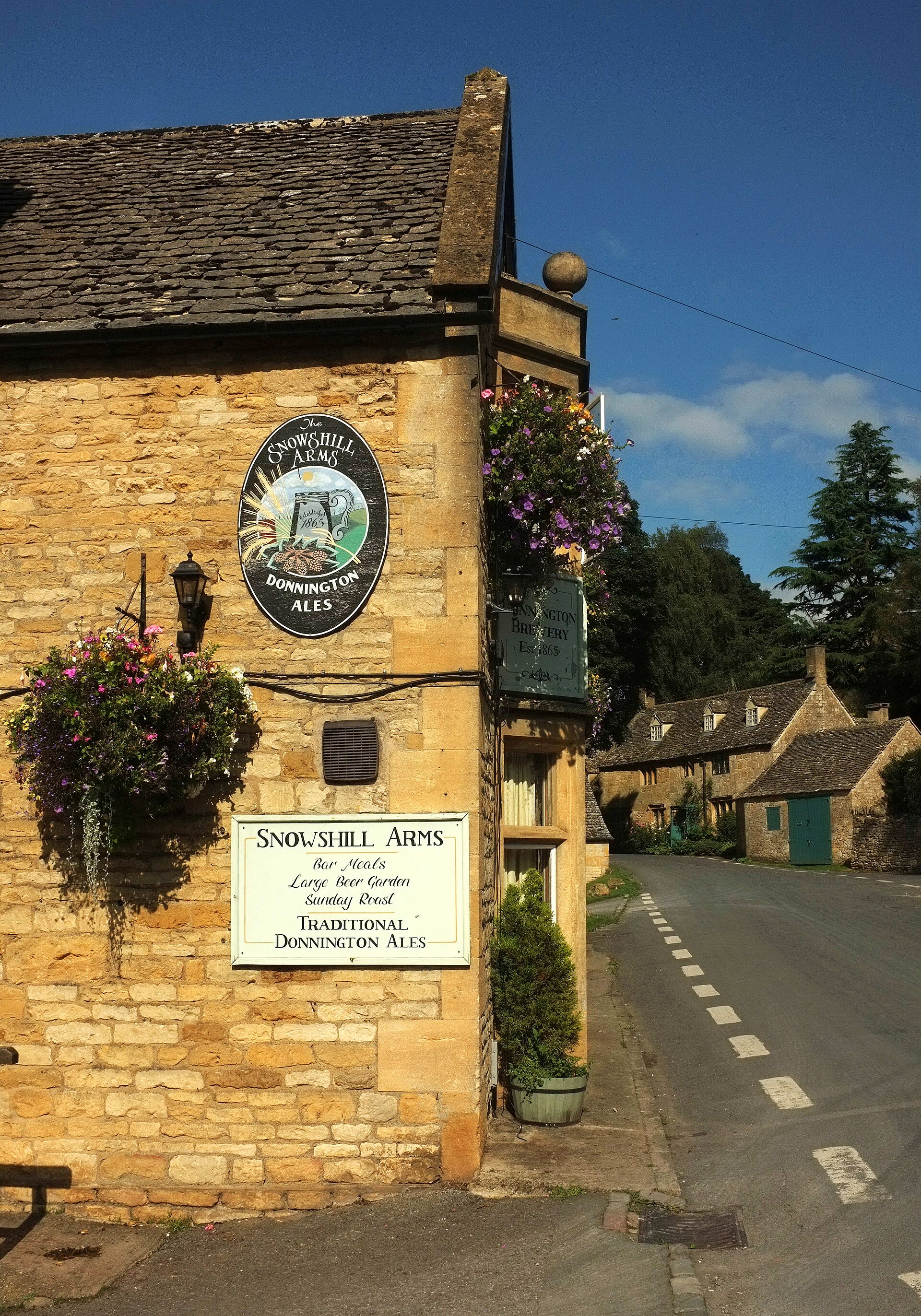 Stone building of the Snowshill Arms beside a village lane