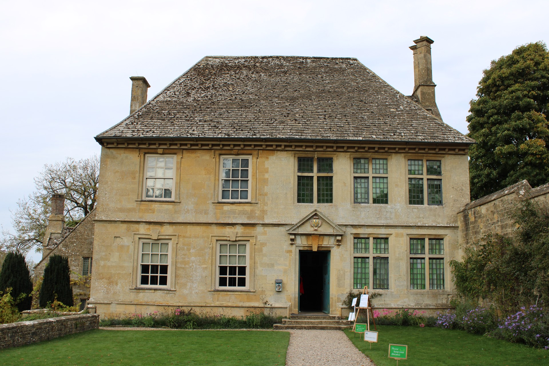 Stone facade and tall chimneys of Snowshill Manor