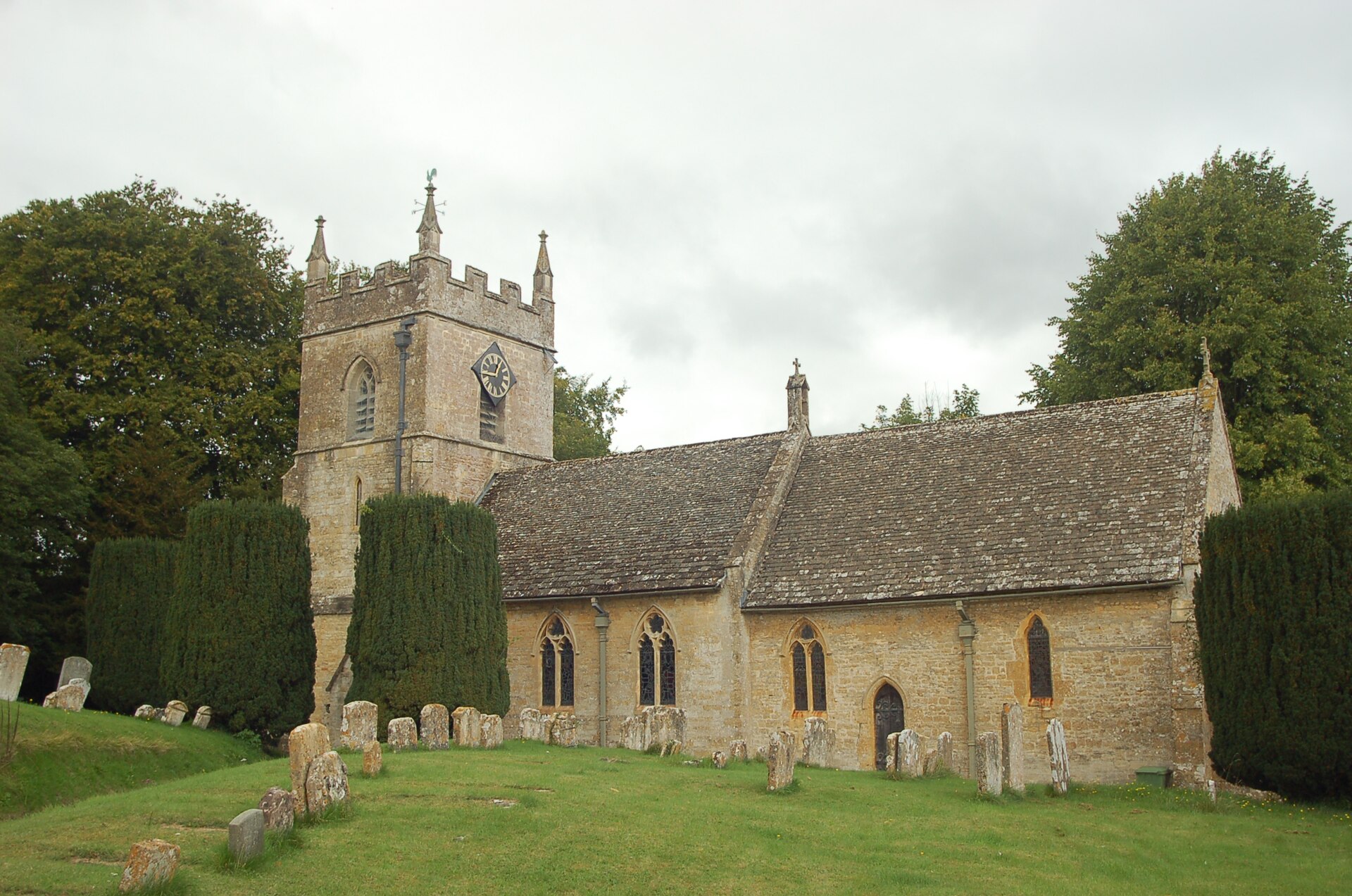 St Peter's Church seen through trees in Upper Slaughter