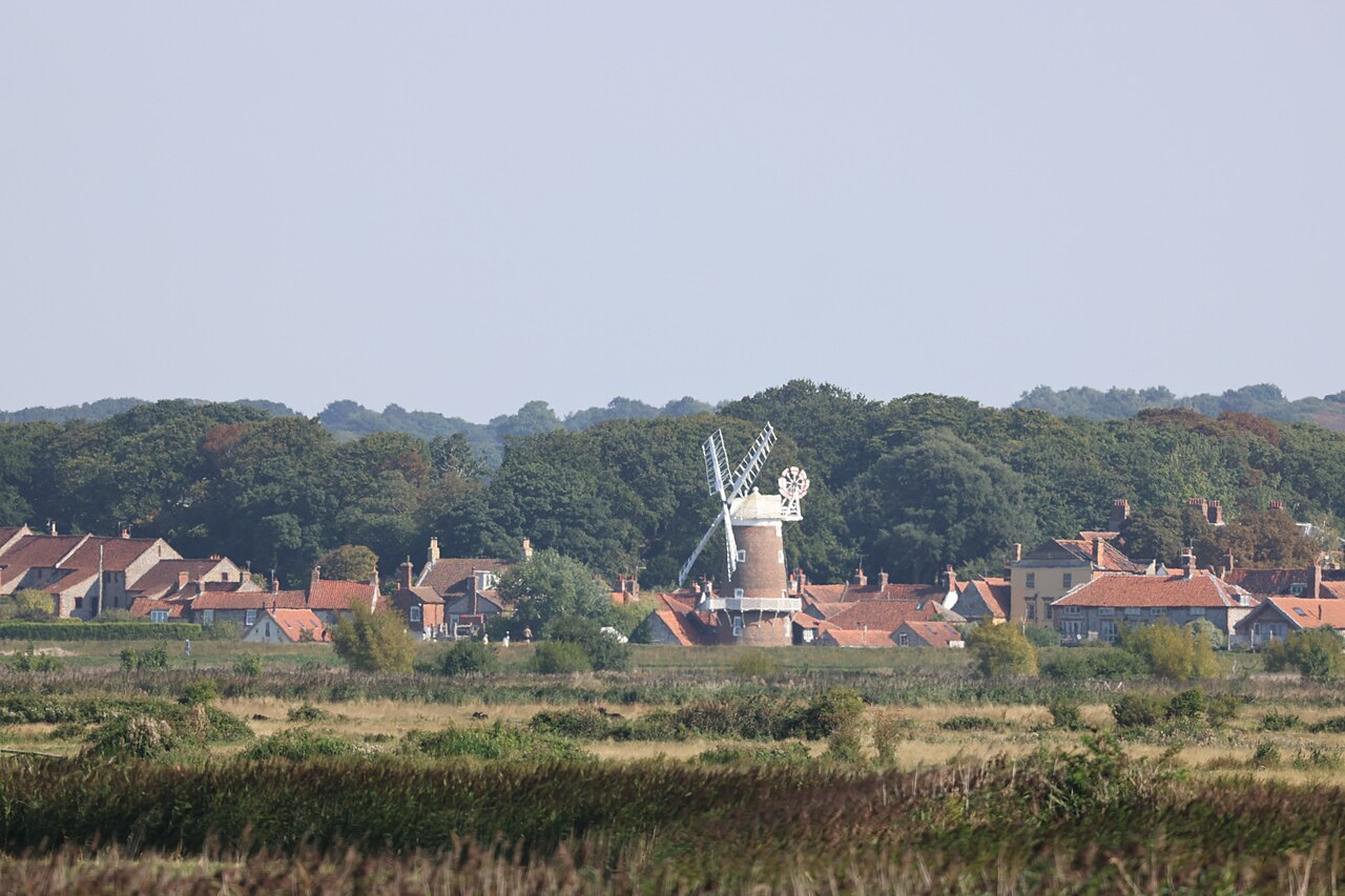 Cley-next-the-Sea seen across fields from the path east of Blakeney